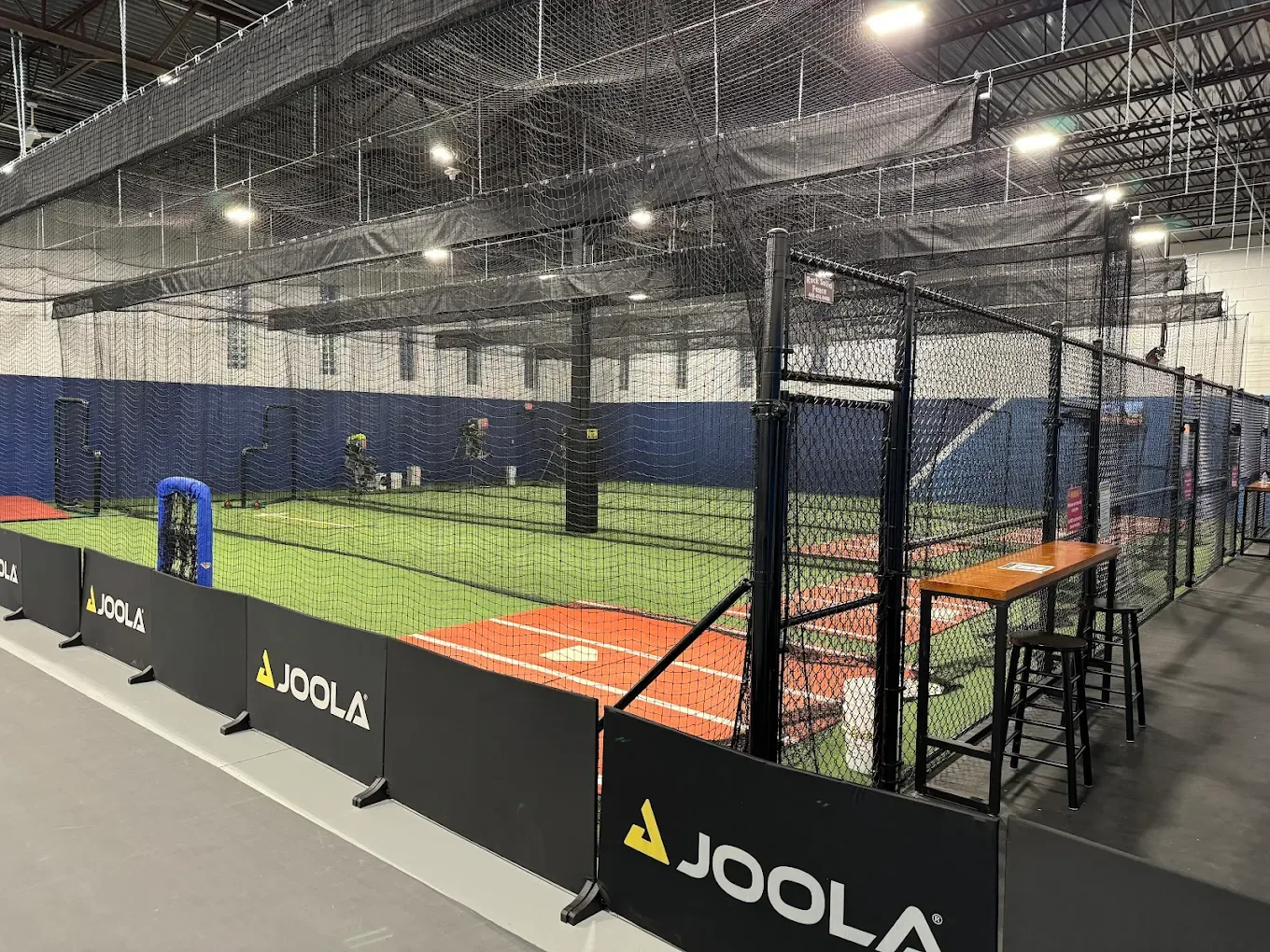 Indoor batting cages with netted lanes at Concord Sports Plex